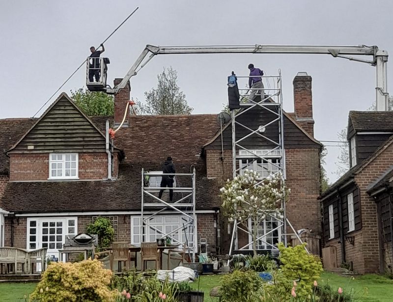 The Moss Cleaners using cherry picker and scaffolding to clean roof safely and professionally in Rugby, Warwickshire